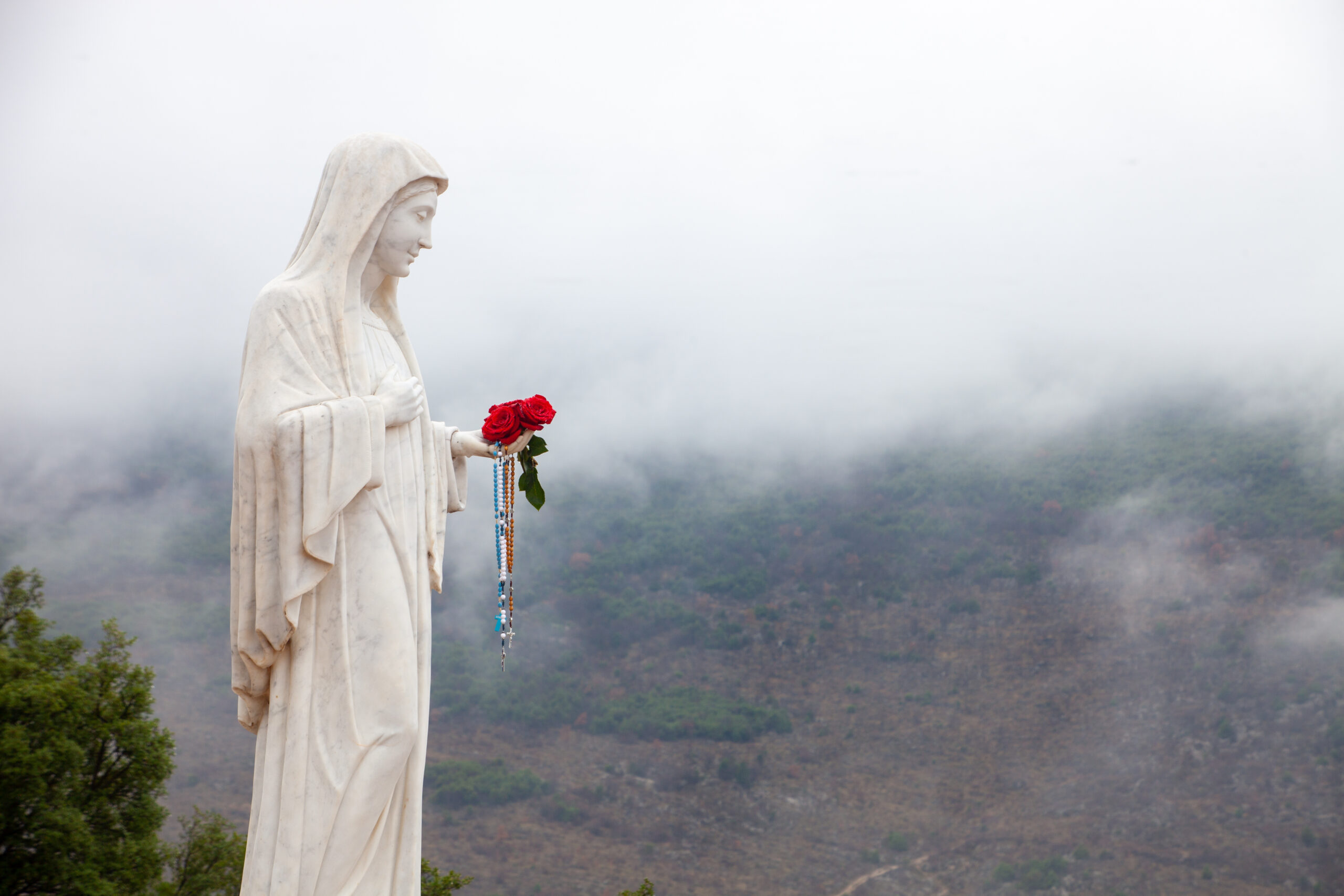 white-statue-of-virgin-mary-in-mountain-area