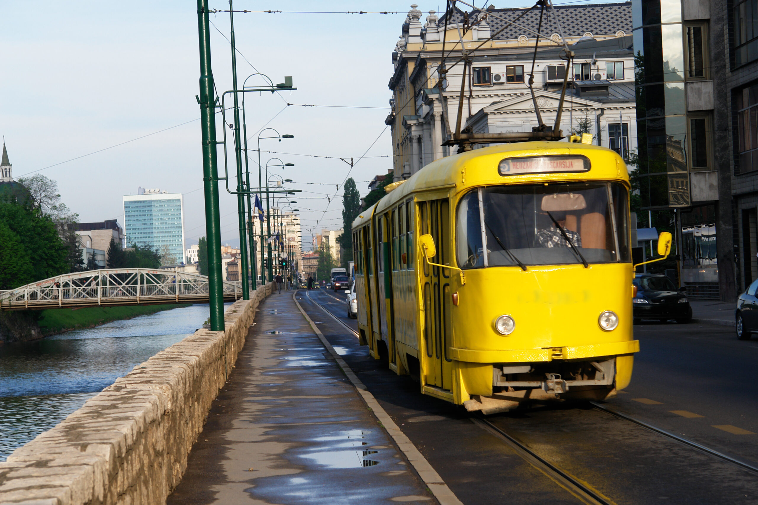 city-scape-along-a-river-with-yellow-traditional-tram